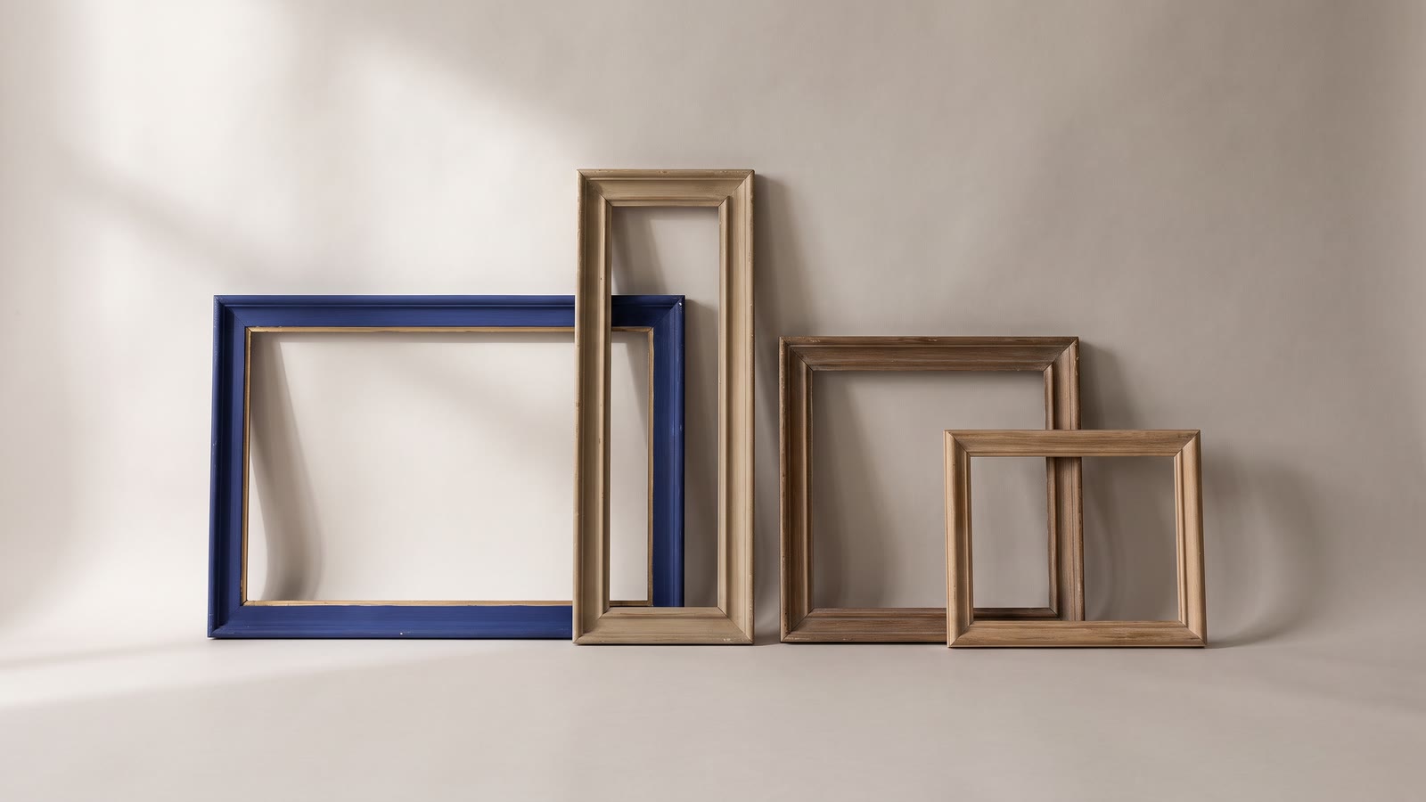 Empty picture frames of different proportions laid side by side