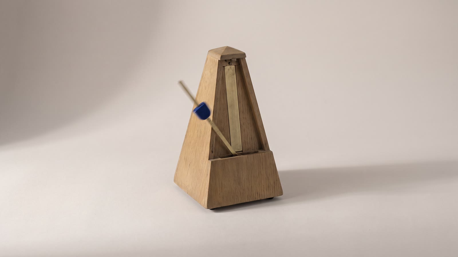 A metronome with its pendulum mid-swing