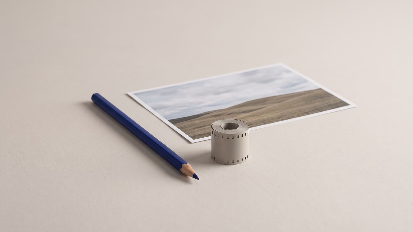 A pencil and a photograph either side of a film reel