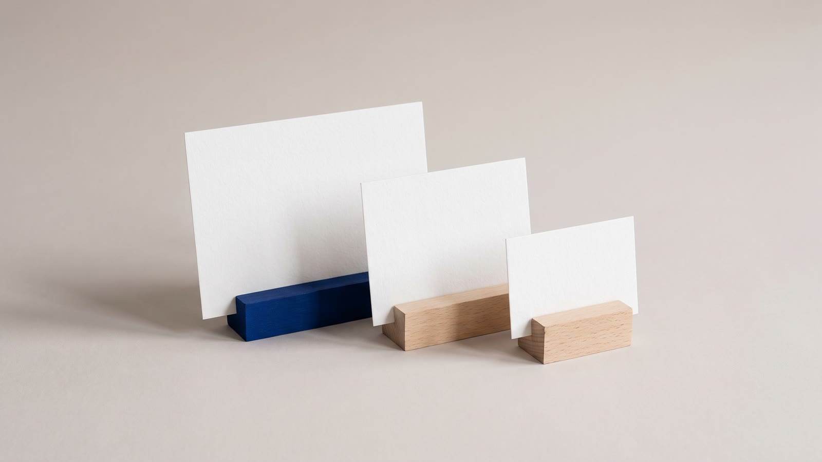 Three blank title cards standing in wooden holders