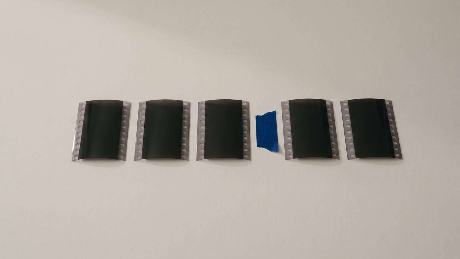 Short pieces of film in a row with a piece of tape between two of them